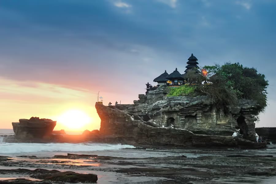 The sea temple of Tanah Lot silhouetted against a Balinese sunset